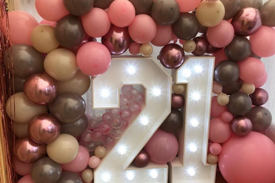 Giant Number 21 surrounded by balloons